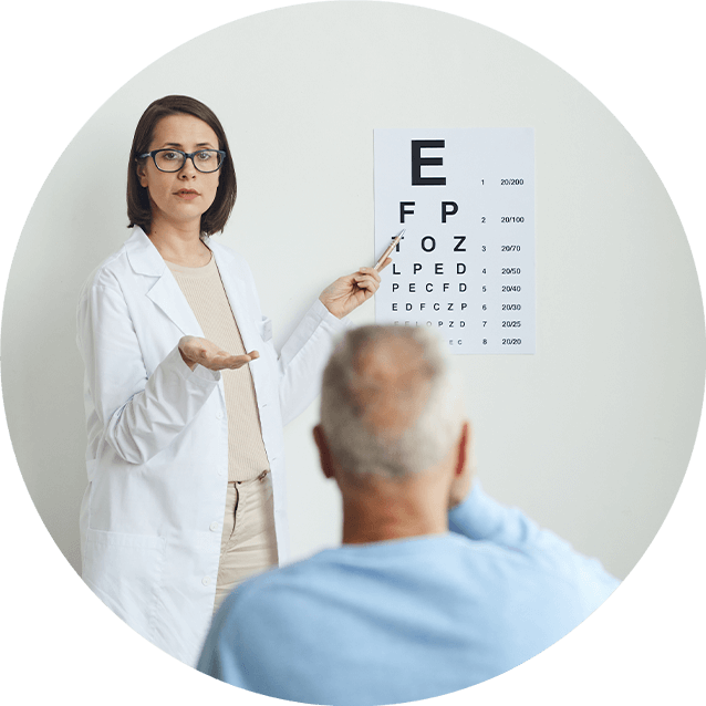 An ophthalmologist showing an eye chart to an older man.