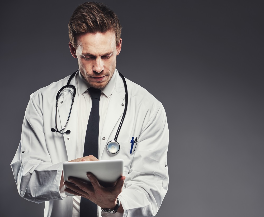 Doctor Ensuring Medical Data Security with Digital Tablet