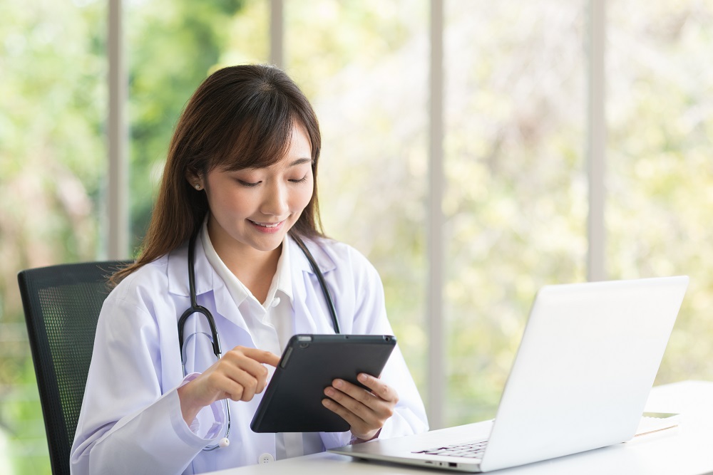 Female doctor using laptop in clinic office