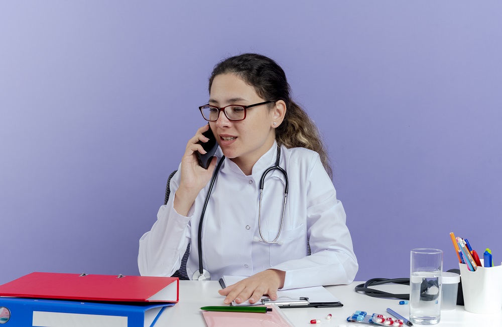 A doctor scheduling an appointment using a medical answering service.